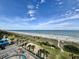 High-angle view of the beach, coastline, and palm trees from the community at 5200 N Ocean Blvd. # 640, Myrtle Beach, SC 29577