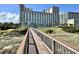 Wooden walkway leads from condo to the beach, with green lawns and seating at 5200 N Ocean Blvd. # 640, Myrtle Beach, SC 29577