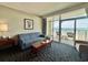 Comfortable living room featuring a cozy sofa and balcony access with stunning ocean views at 5200 N Ocean Blvd. # 640, Myrtle Beach, SC 29577