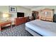 A charming bedroom with a queen bed, flat screen TV, storage, and nearby kitchen at 5200 N Ocean Blvd. # 640, Myrtle Beach, SC 29577