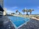 Outdoor pool with ocean view, surrounded by lounge chairs, palm trees, and lifeguard sign at 5200 N Ocean Blvd. # 640, Myrtle Beach, SC 29577