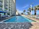 Outdoor pool with ocean view, surrounded by lounge chairs and palm trees at 5200 N Ocean Blvd. # 640, Myrtle Beach, SC 29577