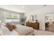 Neutral bedroom with natural light, a wooden dresser, and soft carpet, creating a cozy atmosphere at 523 Blissful Ln., Little River, SC 29566