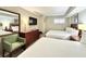 Comfortable bedroom with two beds, dresser, and relaxing decor at 5300 N Ocean Blvd. # 1102, Myrtle Beach, SC 29577