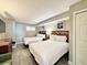 Cozy bedroom featuring two beds with plush linens and neutral decor at 5300 N Ocean Blvd. # 1102, Myrtle Beach, SC 29577