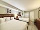 Bright bedroom with two beds, neutral tones, and contemporary furnishings at 5300 N Ocean Blvd. # 1102, Myrtle Beach, SC 29577