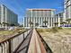 Exterior shot of the condo buildings and boardwalk to the beach at 5300 N Ocean Blvd. # 1102, Myrtle Beach, SC 29577