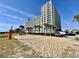 Beachside resort with a beachfront volleyball court and palm trees at 5300 N Ocean Blvd. # 1102, Myrtle Beach, SC 29577