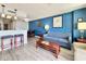 Comfortable living room with blue accent wall, dining area, and breakfast bar at 5300 N Ocean Blvd. # 1102, Myrtle Beach, SC 29577
