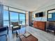 Cozy living room with ocean view, access to balcony, and comfortable seating at 5300 N Ocean Blvd. # 1102, Myrtle Beach, SC 29577