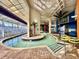 Indoor lazy river and shallow pool area with clear roof, palms and fun paintings at 5300 N Ocean Blvd. # 1102, Myrtle Beach, SC 29577