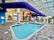 Indoor pool area featuring a fun water slide, shallow pool, lazy river and colorful decor at 5300 N Ocean Blvd. # 1102, Myrtle Beach, SC 29577