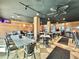 Interior of a restaurant featuring wood paneled walls, decorative ceiling fans, and multiple tables and chairs at 5300 N Ocean Blvd. # 1102, Myrtle Beach, SC 29577