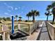 Walkway to beach featuring a shower, palm trees, and ocean views at 5300 N Ocean Blvd. # 1102, Myrtle Beach, SC 29577