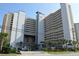 An exterior shot of a beachfront building with a meticulously maintained lawn and ample parking at 5300 N Ocean Blvd. # 410, Myrtle Beach, SC 29577