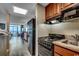 A view into the kitchen area, which features an electric range and a sink, all while overlooking the balcony at 5300 N Ocean Blvd. # 410, Myrtle Beach, SC 29577