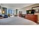 A clean main bedroom featuring a television, wooden furniture, and a view of the ocean at 5300 N Ocean Blvd. # 410, Myrtle Beach, SC 29577
