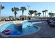 Outdoor pool featuring palm trees, dolphin accents, lounge chairs, and a shallow water area for  at 5300 N Ocean Blvd. # 410, Myrtle Beach, SC 29577