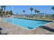 Outdoor pool with ocean view, lounge chairs, and palm trees at 5300 N Ocean Blvd. # 410, Myrtle Beach, SC 29577