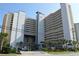 Beautiful multi-story condo building with blue and white accents, palm trees, and a well-maintained landscape at 5300 Ocean Blvd. N # 903, Myrtle Beach, SC 29577