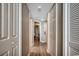 Bright hallway featuring wood-look flooring and multiple doors, offering access to various rooms within the unit at 5300 Ocean Blvd. N # 903, Myrtle Beach, SC 29577