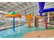 Indoor pool area boasting a colorful water play structure, umbrella fountain, and playful parrot accents at 5300 Ocean Blvd. N # 903, Myrtle Beach, SC 29577