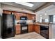 Functional kitchen featuring modern appliances, wood cabinets, and granite countertops, adjacent to the living space at 5300 Ocean Blvd. N # 903, Myrtle Beach, SC 29577