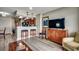 Interior view of open living space with bar stool seating, kitchen, tv, and comfortable chair at 5300 Ocean Blvd. N # 903, Myrtle Beach, SC 29577