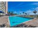 Sparkling outdoor pool area with sun loungers, palm trees, and clear blue skies at 5300 Ocean Blvd. N # 903, Myrtle Beach, SC 29577