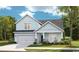 Charming two-story home featuring a front porch, a two-car garage, and classic coastal curb appeal at 541 Magnolia Terrace Dr, Myrtle Beach, SC 29579