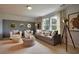Cozy living room with comfortable seating, shiplap accent wall, and two sunny windows at 541 Magnolia Terrace Dr, Myrtle Beach, SC 29579