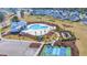 Aerial view showcasing community pool, tennis courts, playground, and surrounding homes at 5545 Whitebark Dr., Myrtle Beach, SC 29577
