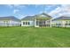 Wide view of the fenced backyard and the rear exterior of the home at 5545 Whitebark Dr., Myrtle Beach, SC 29577