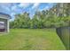 Manicured backyard with a fence, lush green grass, and surrounding trees at 5545 Whitebark Dr., Myrtle Beach, SC 29577