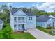 Beautiful two-story home featuring a double front porch and a two-car garage at 5545 Whitebark Dr., Myrtle Beach, SC 29577