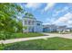 Charming two-story home with a manicured lawn and a welcoming double porch at 5545 Whitebark Dr., Myrtle Beach, SC 29577