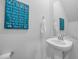 Clean powder room with bright blue nautical themed decorations, modern fixtures and decor at 5545 Whitebark Dr., Myrtle Beach, SC 29577