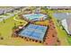 An aerial view of the tennis and pickleball courts and pool with cabana at the community center at 57 Eagle Claw Dr., Carolina Shores, NC 28467