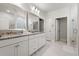 Bright bathroom features a double vanity with granite countertop and a large framed mirror at 57 Eagle Claw Dr., Carolina Shores, NC 28467