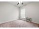 Clean, empty bedroom with beige carpet and a window bringing in natural light at 57 Eagle Claw Dr., Carolina Shores, NC 28467