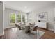 Elegant dining room with a modern table, stylish chairs, a buffet, and large windows at 57 Eagle Claw Dr., Carolina Shores, NC 28467