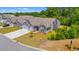 Well-maintained gray home with a two-car garage, green lawn, and lush landscaping at 57 Eagle Claw Dr., Carolina Shores, NC 28467