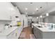 Bright kitchen featuring white cabinets, stainless appliances, and a stylish island with a sink at 57 Eagle Claw Dr., Carolina Shores, NC 28467