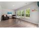 Bright living room featuring wood floors, large windows, and lots of natural light at 57 Eagle Claw Dr., Carolina Shores, NC 28467
