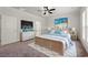 Stylish main bedroom with a modern bed, a wall-mounted TV, and natural light from the windows at 57 Eagle Claw Dr., Carolina Shores, NC 28467