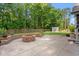 Spacious backyard featuring a brick fire pit, shed and a wooded backdrop at 57 River Birch Ln., Pawleys Island, SC 29585