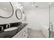 Modern bathroom with double vanity, sleek black countertops, and elegant fixtures for a luxurious experience at 57 River Birch Ln., Pawleys Island, SC 29585