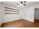 Bedroom featuring hardwood flooring, ceiling fan, a closet, and custom shelving at 57 River Birch Ln., Pawleys Island, SC 29585