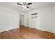 Bedroom featuring hardwood flooring, ceiling fan, a closet, and custom shelving at 57 River Birch Ln., Pawleys Island, SC 29585