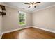 A bedroom features hardwood flooring, ceiling fan, a window with exterior views at 57 River Birch Ln., Pawleys Island, SC 29585